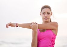 Photography of Woman in Pink Tank Top Stretching Arm